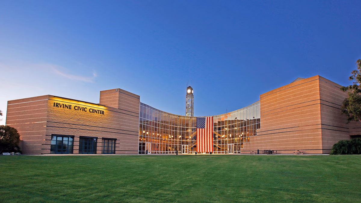 Irvine City Hall building displays American flag.