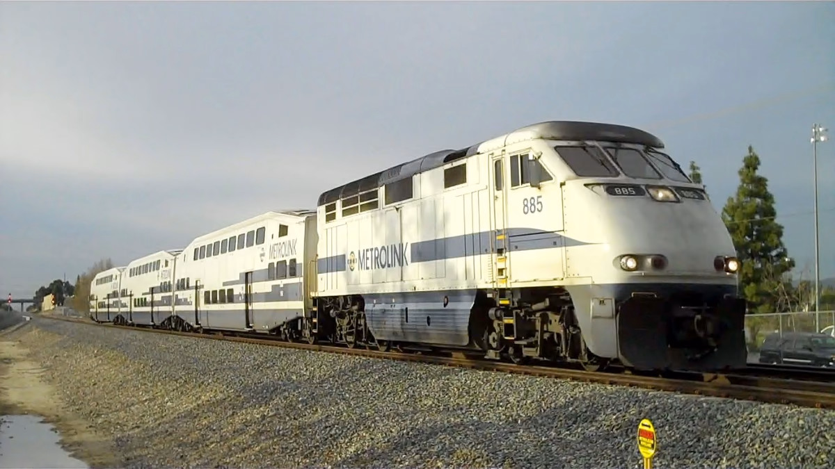 A Metrolink train passes Heroes Park, Lake Forest, California, United States.