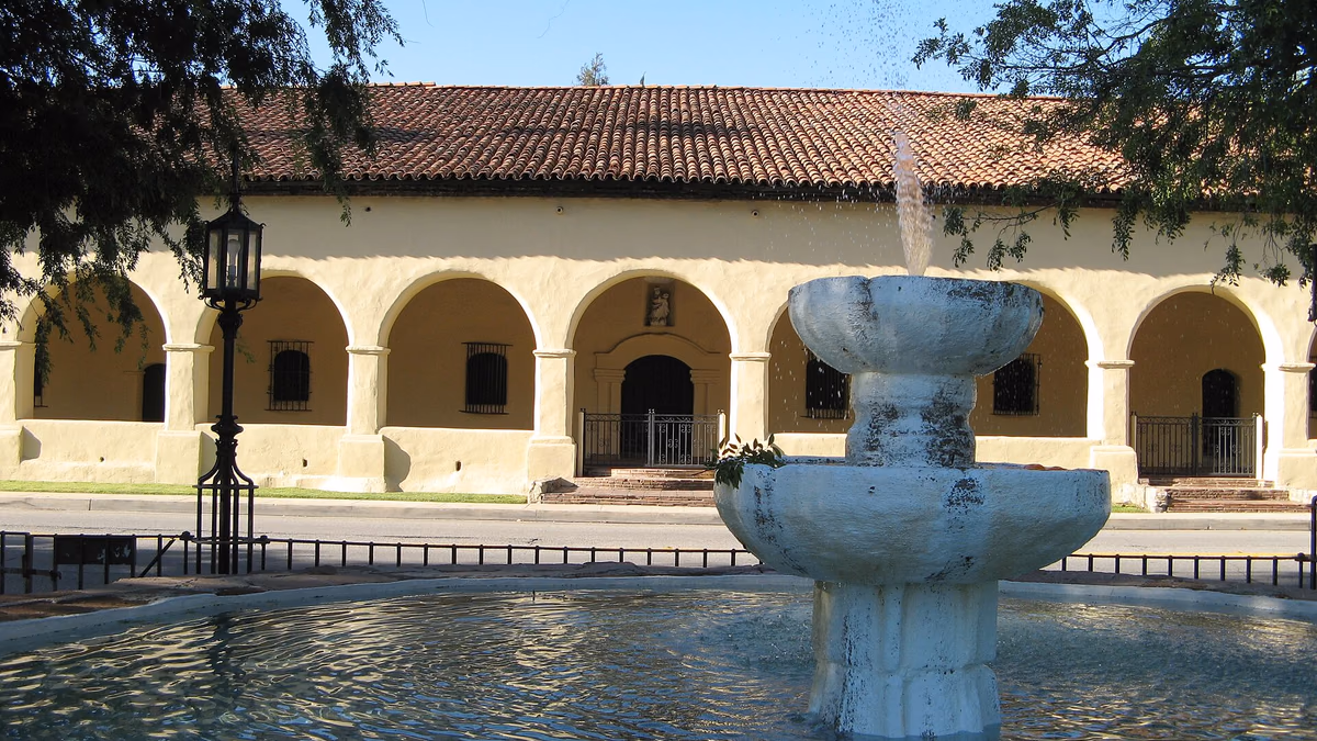 Fountain in gardens of Brand Park . Arcade of Mission San Fernando Rey de España across the street. Located in Mission Hills , San Fernando Valley, Los Angeles.