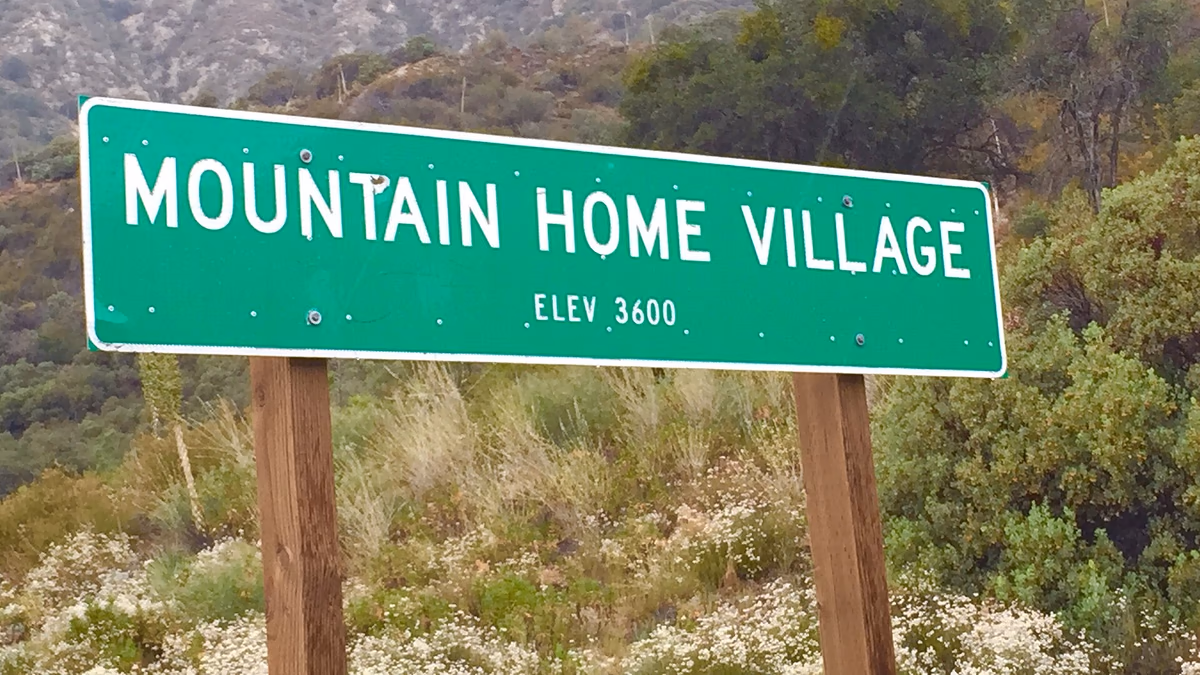 Sign by city limits of Mountain Home Village, CA.