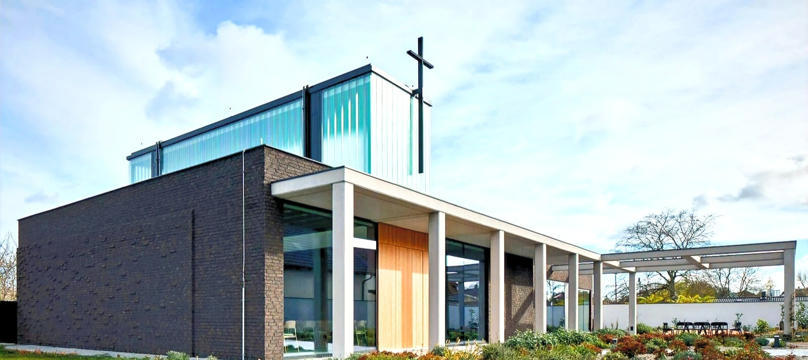 A modern church building with a cross above the sanctuary
