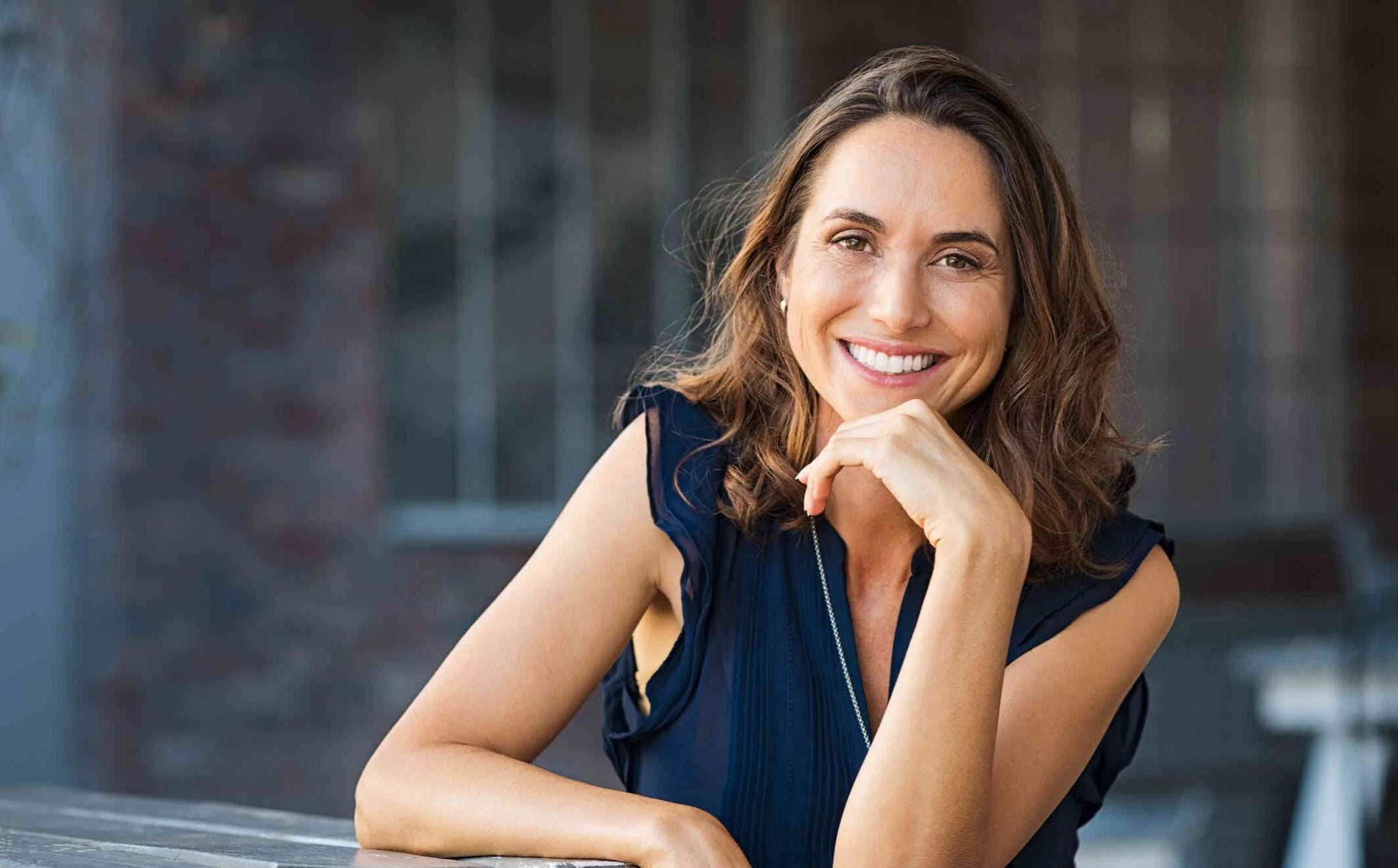 A woman smiling in a calm professional setting