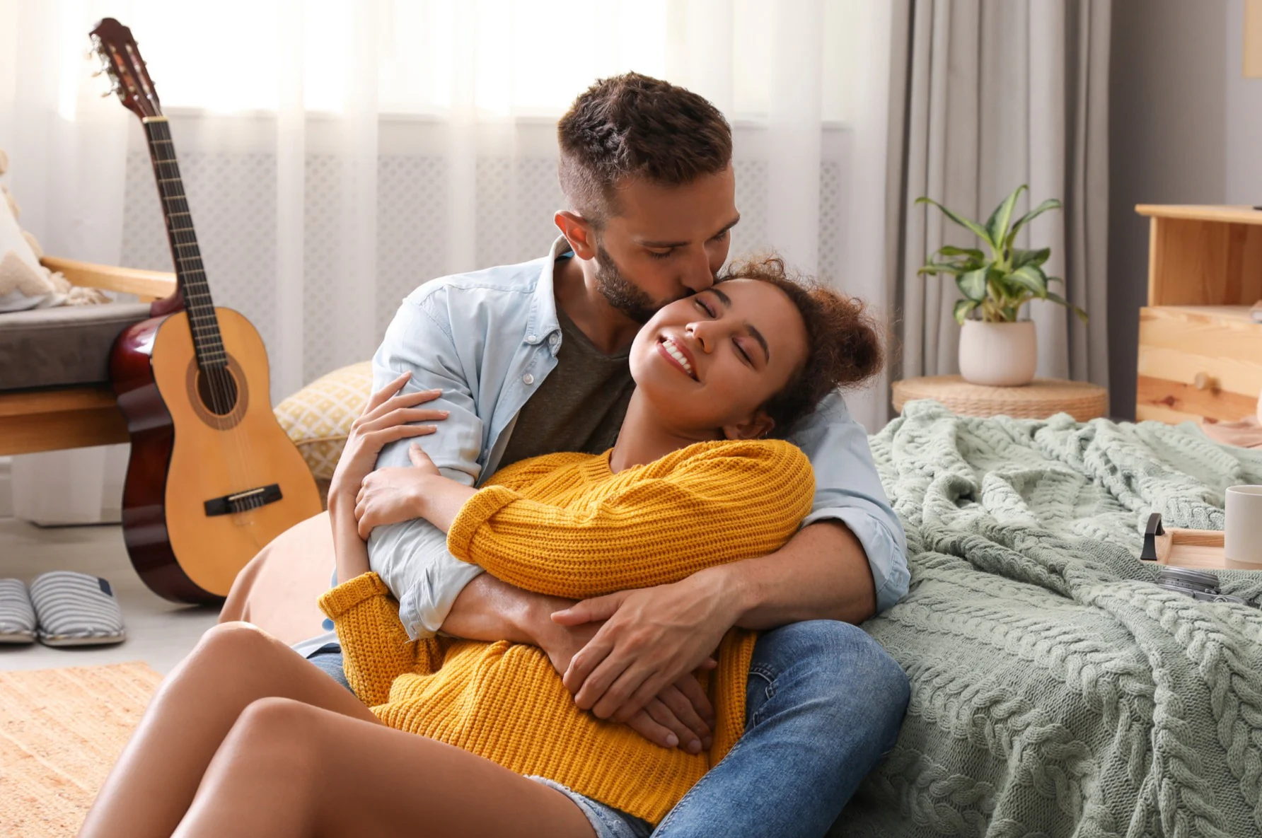 A couple embracing at home