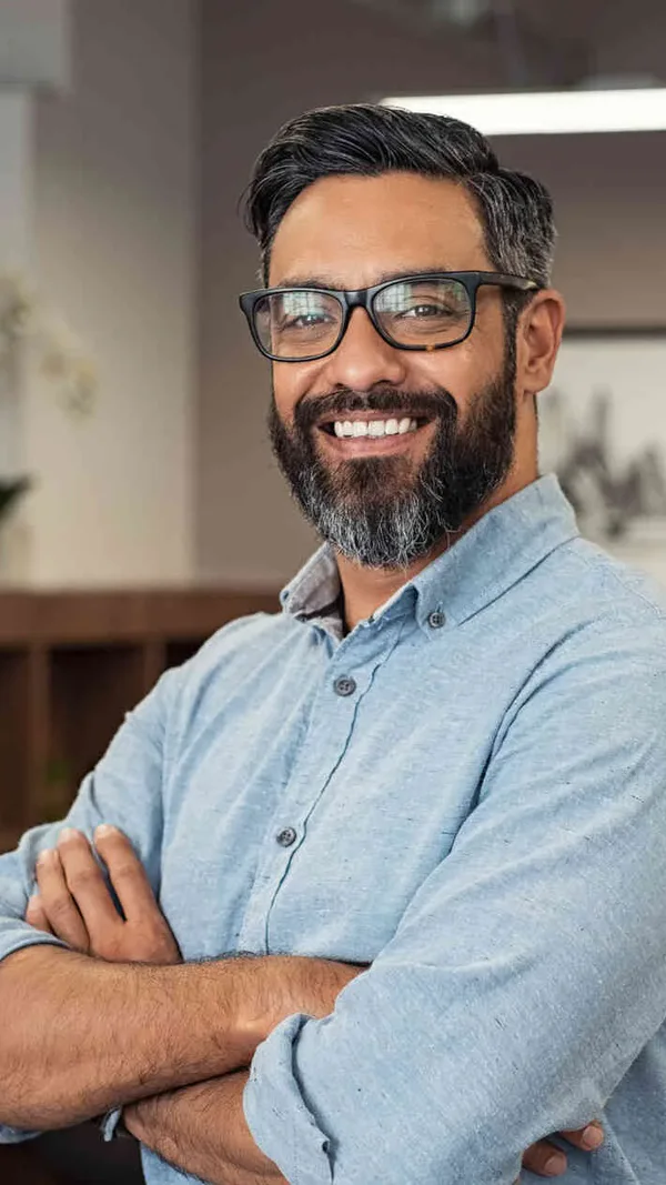 A man smiling in a calm office setting