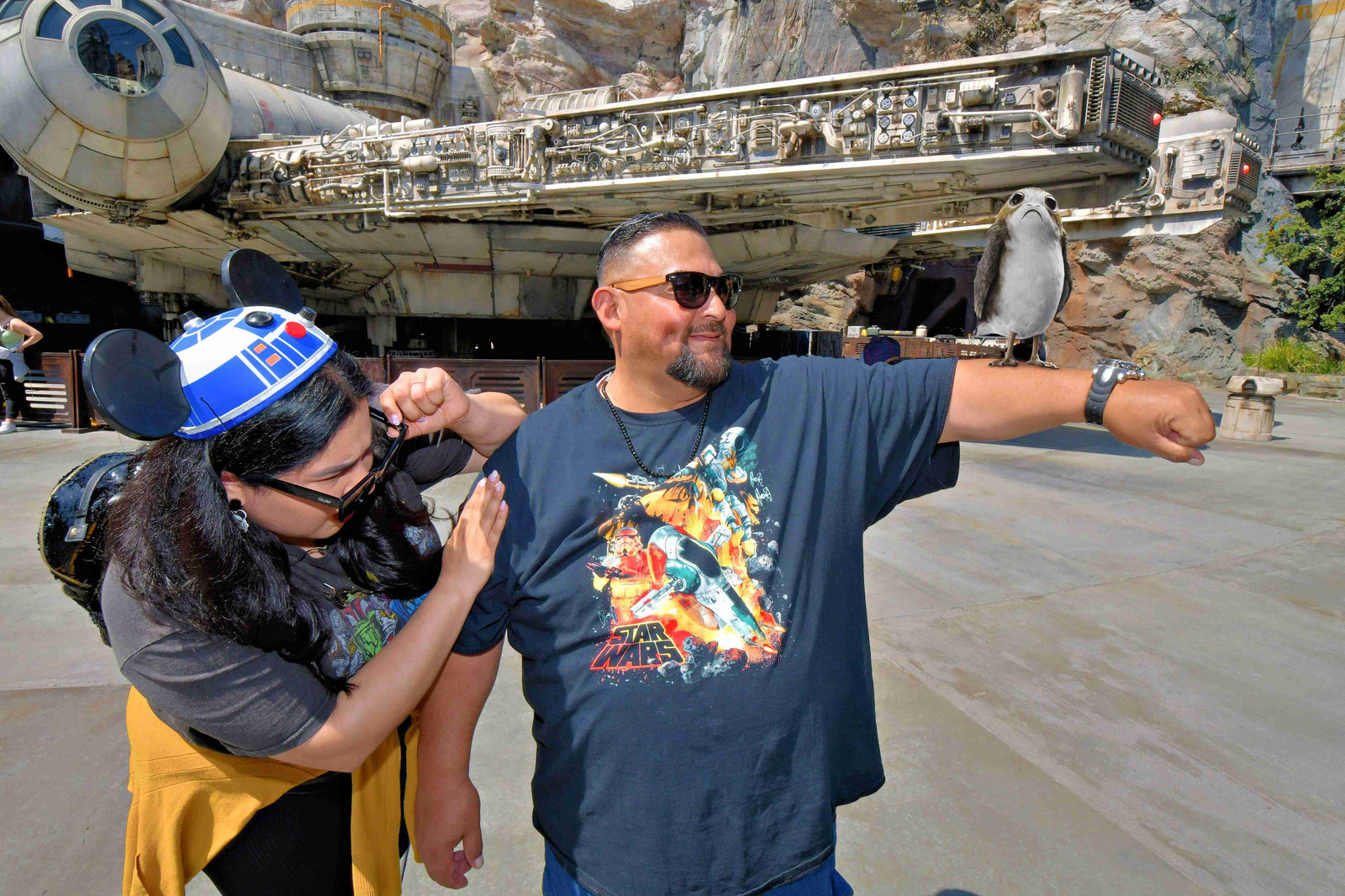 A Latina women and her father enjoying a Star Wars exhibit at Disneyland together.